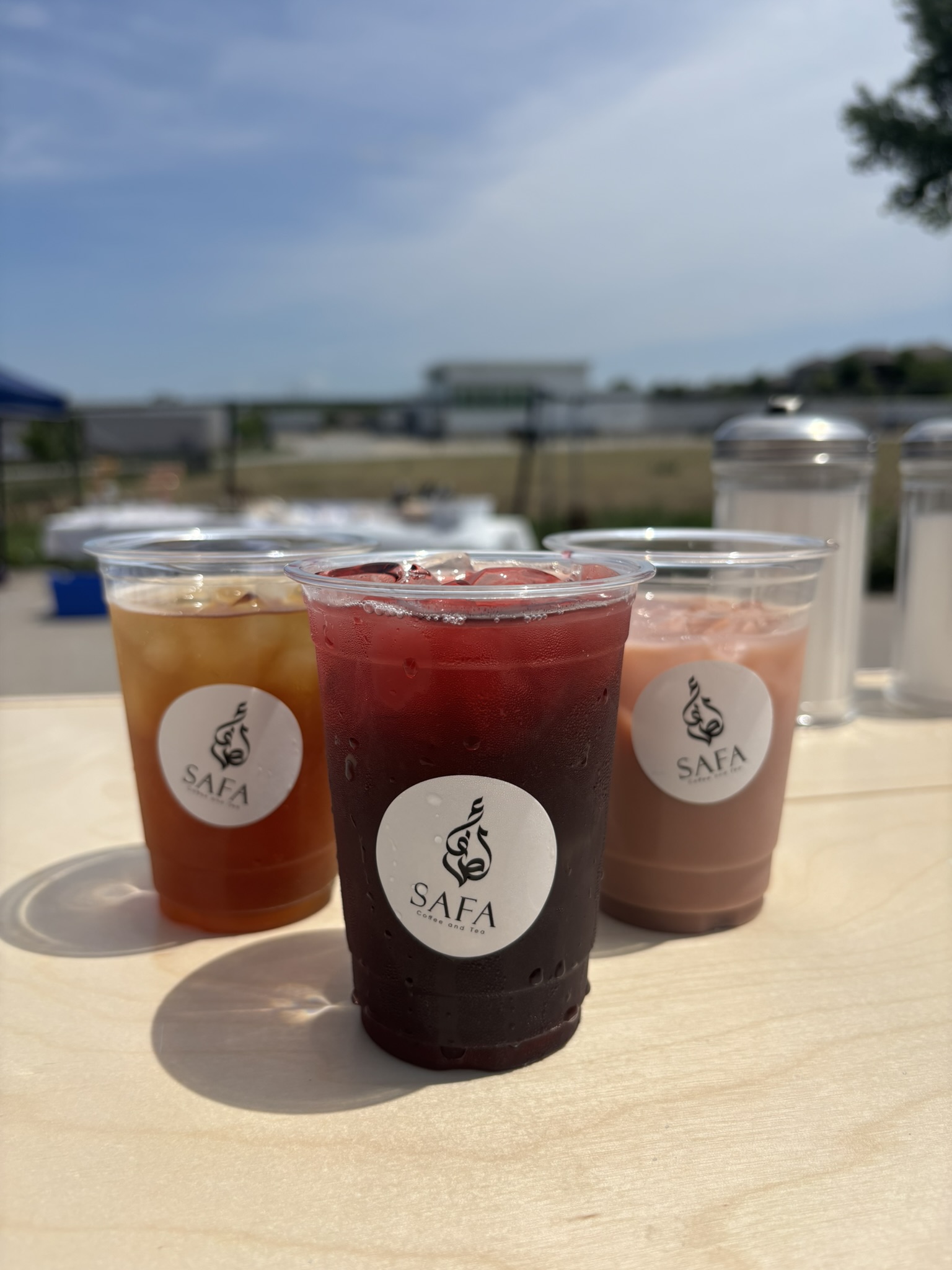 Three iced Safa drinks ready to serve at an outdoor gathering